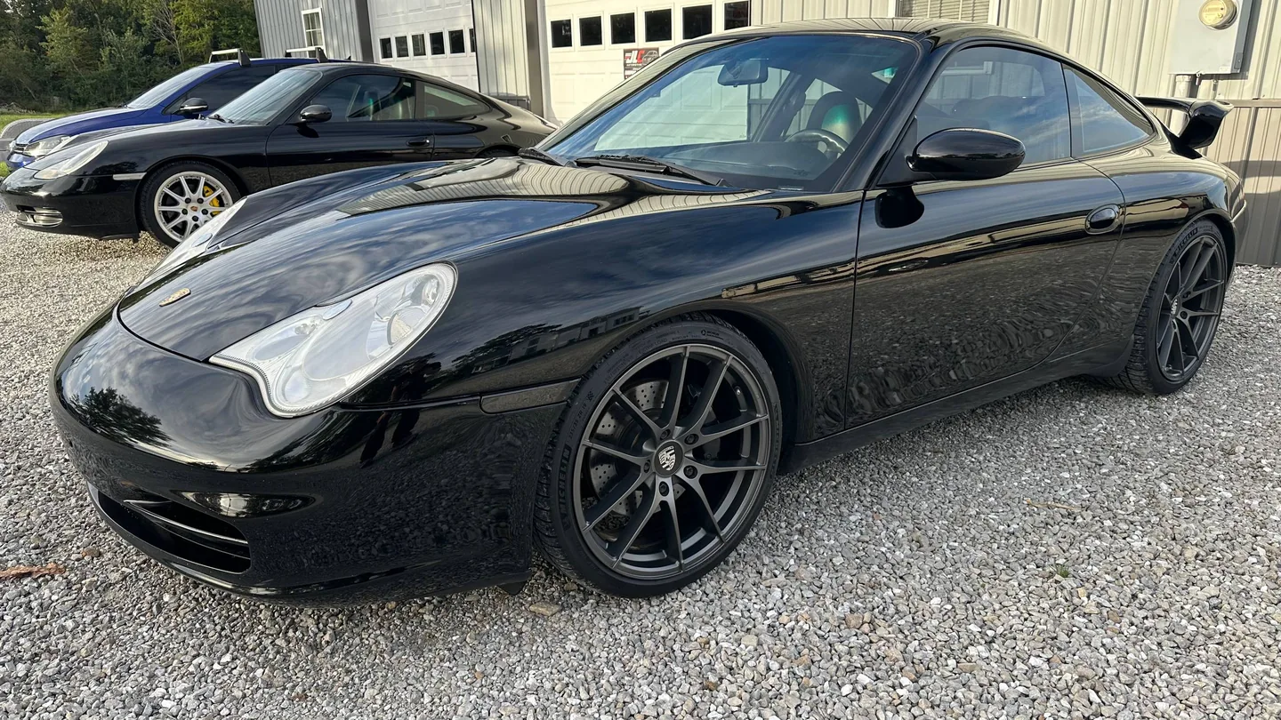 Black sports coupe photographed outdoors