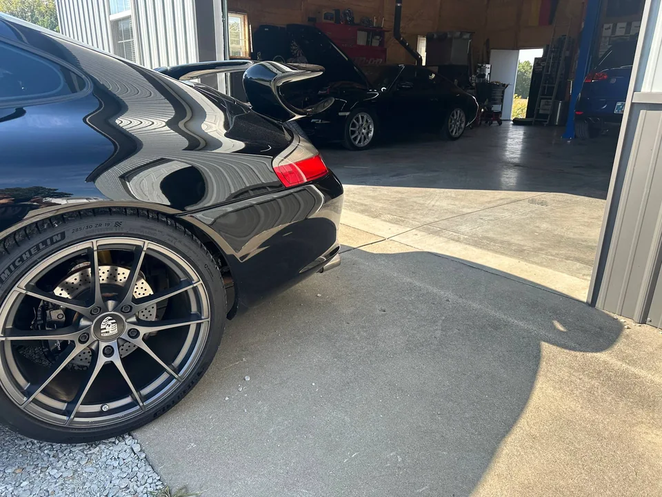 Black car bodywork and wheel